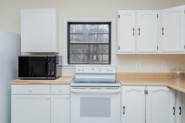 kitchen featuring white cabinetry and white electric range oven