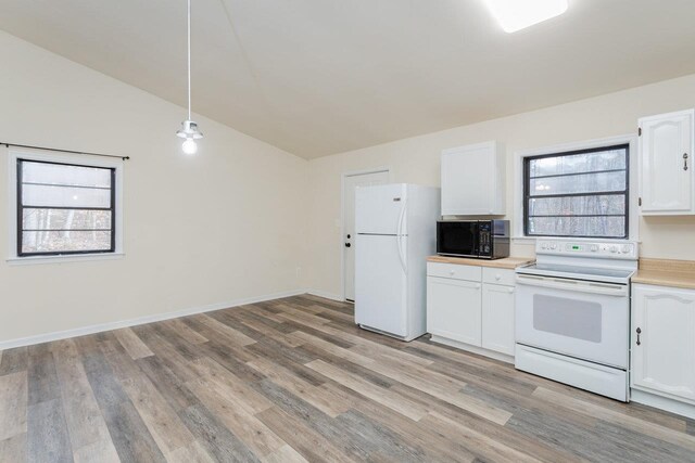 kitchen with vaulted ceiling, white cabinetry, hanging light fixtures, light hardwood / wood-style floors, and white appliances