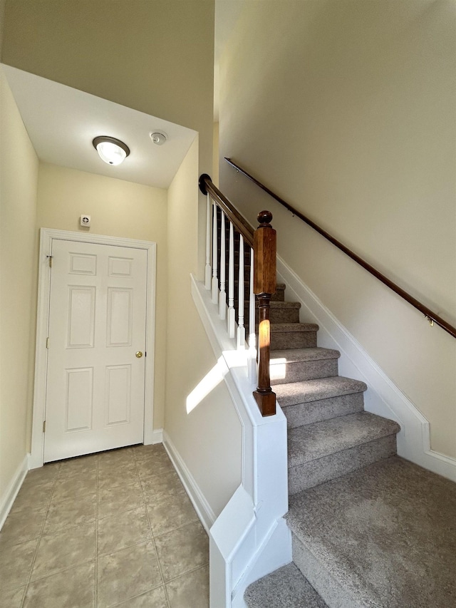 stairs featuring tile patterned floors