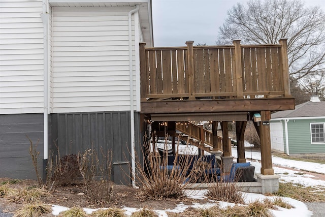 view of snow covered exterior featuring a wooden deck