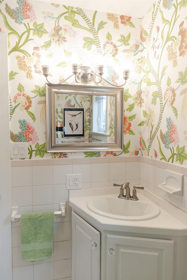 bathroom with vanity and tile walls