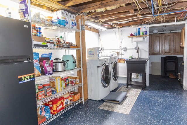 clothes washing area featuring separate washer and dryer and sink