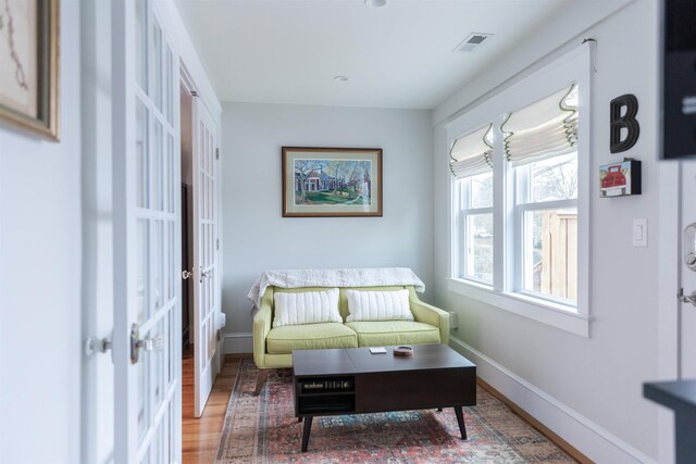 sitting room featuring french doors and wood-type flooring