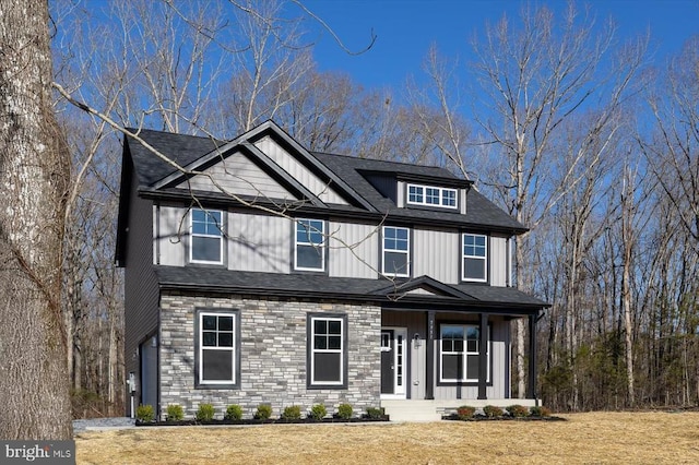 view of front facade with a front lawn and roof with shingles