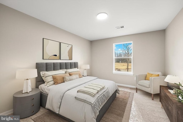 bedroom with baseboards and light carpet