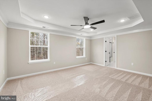 carpeted empty room with a tray ceiling, a ceiling fan, recessed lighting, and baseboards