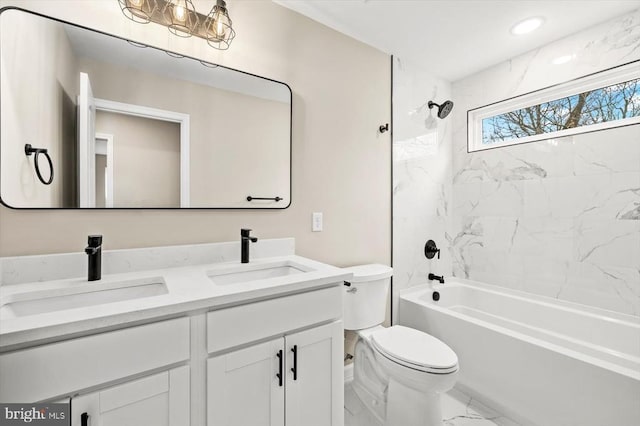 bathroom featuring marble finish flooring, toilet, double vanity, and shower / bathtub combination