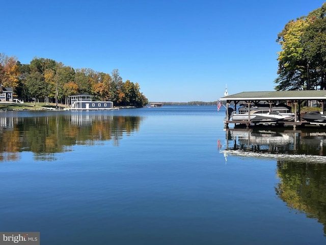 dock area featuring boat lift and a water view