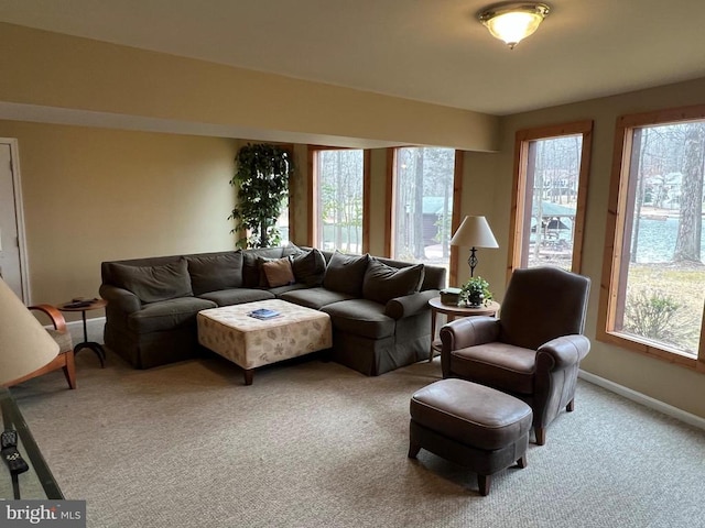 carpeted living room featuring baseboards