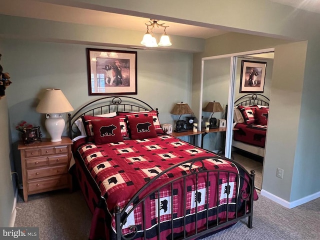 carpeted bedroom with baseboards and a closet