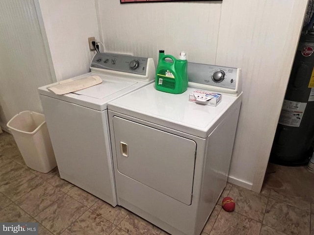 laundry room with separate washer and dryer, water heater, and laundry area
