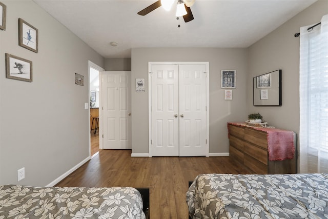 bedroom featuring baseboards, a closet, and wood finished floors
