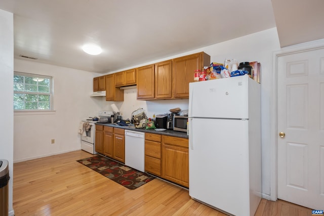 1122 Preston Ave Unit A-B, Charlottesville, VA 22903 - kitchen with white appliances, light wood-style floors, under cabinet range hood, and dark countertops