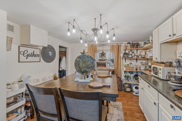 325 10 1/2 St NW, Charlottesville, VA 22903 - dining room featuring a chandelier and light wood-style floors