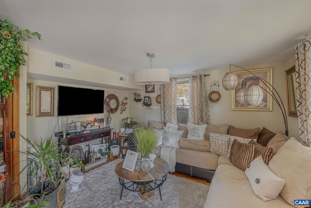 living room with visible vents and wood finished floors