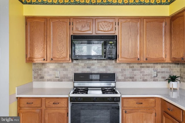 10718 Brice Ct, Fredericksburg, VA 22407 - kitchen featuring black microwave, range with gas stovetop, light countertops, and decorative backsplash