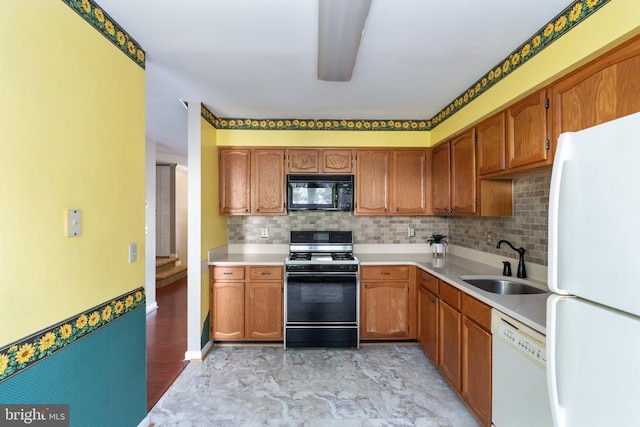 10718 Brice Ct, Fredericksburg, VA 22407 - kitchen featuring white appliances, a sink, light countertops, backsplash, and brown cabinetry