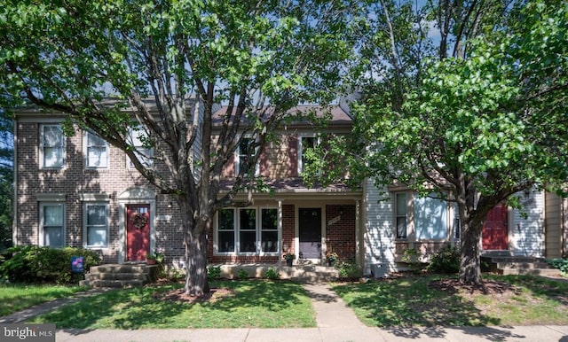 10718 Brice Ct, Fredericksburg, VA 22407 - view of property hidden behind natural elements featuring brick siding and a front yard