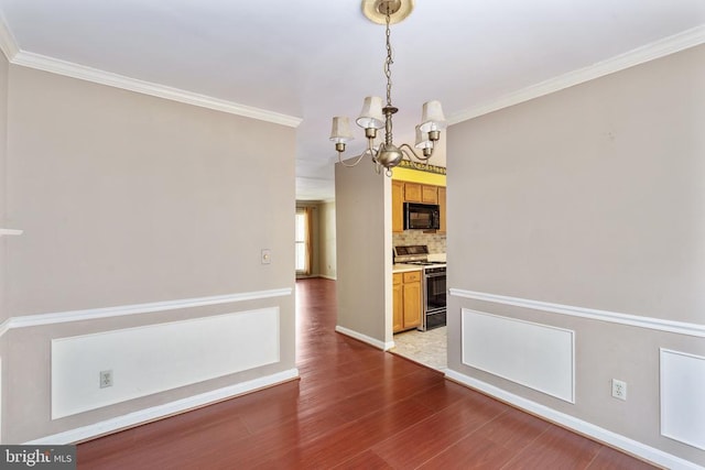 10718 Brice Ct, Fredericksburg, VA 22407 - unfurnished dining area featuring a chandelier, light wood-style floors, ornamental molding, and baseboards
