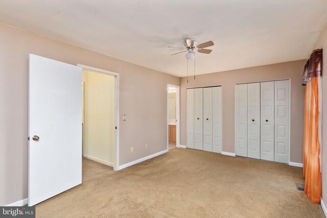 10718 Brice Ct, Fredericksburg, VA 22407 - unfurnished bedroom featuring light carpet, two closets, baseboards, ensuite bath, and ceiling fan