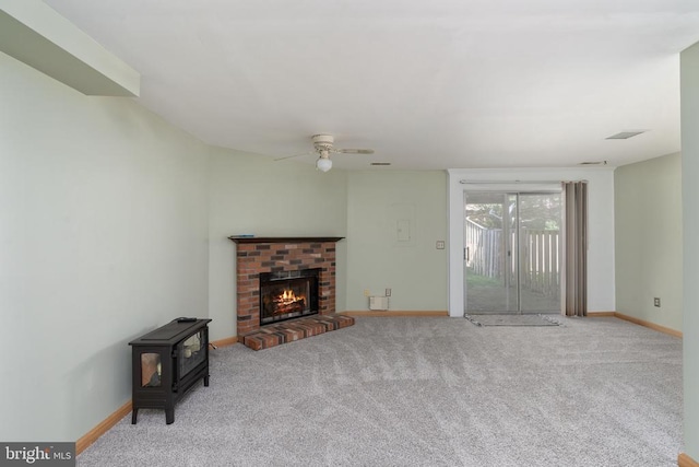 10718 Brice Ct, Fredericksburg, VA 22407 - unfurnished living room featuring carpet flooring, baseboards, and a wood stove