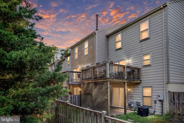 10718 Brice Ct, Fredericksburg, VA 22407 - back of house at dusk with fence, central air condition unit, and a wooden deck