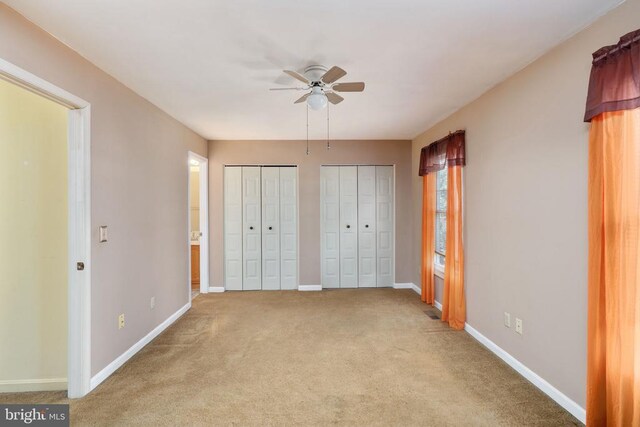 10718 Brice Ct, Fredericksburg, VA 22407 - unfurnished bedroom with multiple closets, carpet floors, baseboards, ensuite bathroom, and ceiling fan