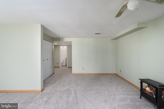 10718 Brice Ct, Fredericksburg, VA 22407 - carpeted empty room with a wood stove and baseboards