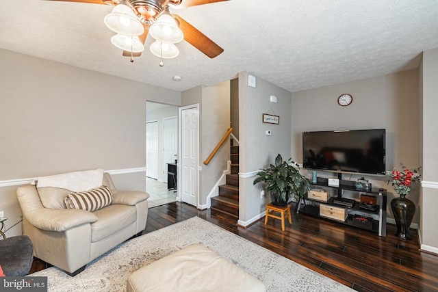9910 Warwick Pl, Fredericksburg, VA 22408 - living room featuring hardwood / wood-style floors, ceiling fan, stairs, baseboards, and a textured ceiling