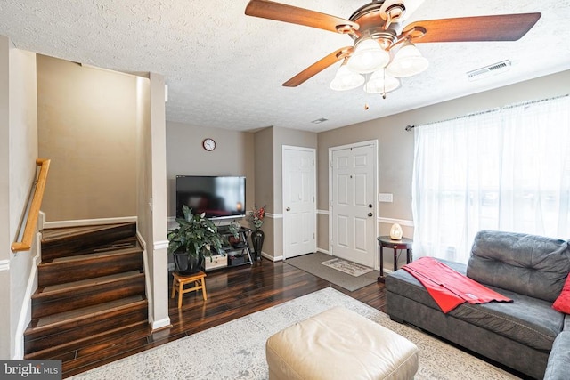 9910 Warwick Pl, Fredericksburg, VA 22408 - living room featuring wood finished floors, a ceiling fan, a textured ceiling, stairway, and baseboards