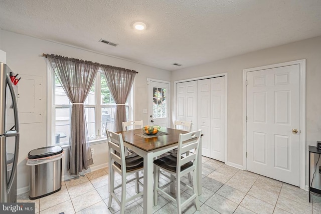 9910 Warwick Pl, Fredericksburg, VA 22408 - dining room with light tile patterned floors, baseboards, and a textured ceiling