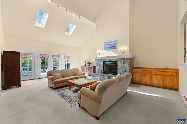 1972 Sclaters Ford Rd, Palmyra, VA 22963 - living area featuring high vaulted ceiling, rail lighting, light colored carpet, a fireplace, and a skylight