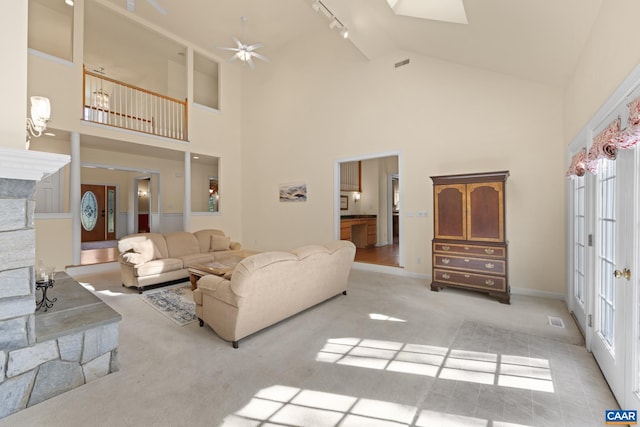 1972 Sclaters Ford Rd, Palmyra, VA 22963 - living room with high vaulted ceiling, light carpet, rail lighting, ceiling fan, and baseboards