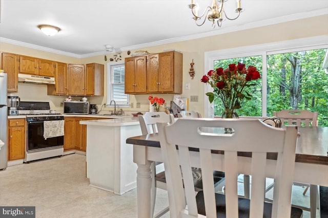 9814 Dominion Forest Cir, Fredericksburg, VA 22408 - kitchen with range with gas cooktop, under cabinet range hood, light countertops, a peninsula, and brown cabinetry