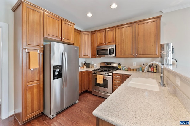 2153 Saranac Ct, Charlottesville, VA 22911 - kitchen with recessed lighting, brown cabinetry, a sink, wood finished floors, and stainless steel appliances
