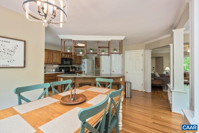 168 Lakeland Ln, Faber, VA 22938 - dining room featuring light wood-style flooring, a chandelier, decorative columns, and crown molding