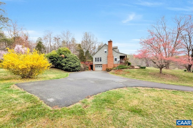 168 Lakeland Ln, Faber, VA 22938 - view of property exterior featuring a chimney, asphalt driveway, a garage, and a lawn
