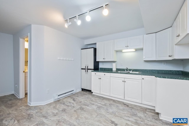 168 Lakeland Ln, Faber, VA 22938 - kitchen with baseboard heating, dark countertops, track lighting, and white cabinets