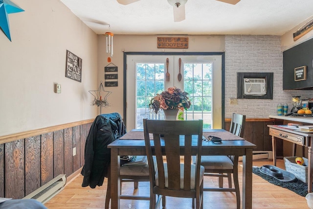 9274 Spotswood Trl, Mcgaheysville, VA 22840 - dining area with light wood finished floors, a ceiling fan, an AC wall unit, a baseboard radiator, and a textured ceiling