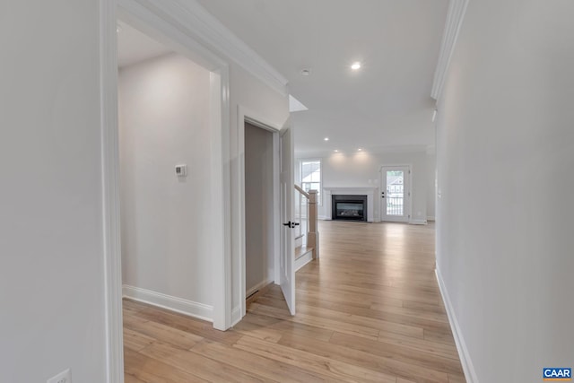 hall with baseboards, recessed lighting, ornamental molding, and light wood-type flooring