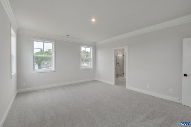 carpeted empty room with baseboards, ornamental molding, and visible vents