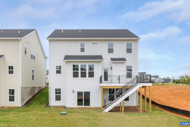 rear view of property featuring a yard, a deck, and stairway