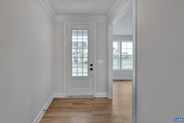 entryway featuring crown molding, baseboards, and wood finished floors