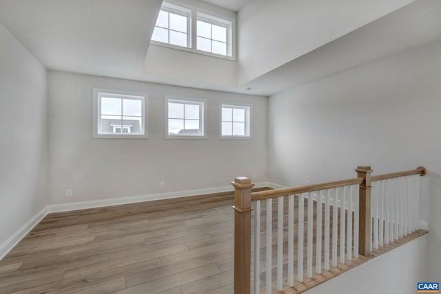 spare room featuring wood finished floors and baseboards
