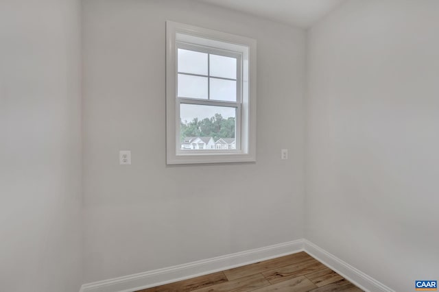 empty room featuring light wood-style floors and baseboards