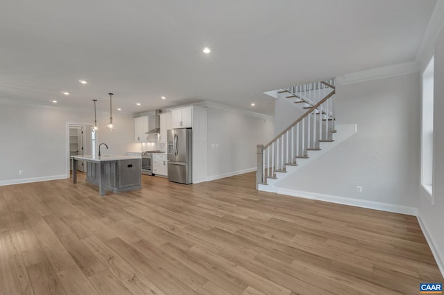 unfurnished living room with stairway, crown molding, light wood-style flooring, and baseboards