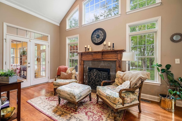 1763 Red Top Orchard Rd, Waynesboro, VA 22980 - sitting room featuring crown molding, high vaulted ceiling, a fireplace, wood finished floors, and french doors