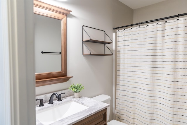 bathroom featuring toilet, a shower with curtain, and vanity