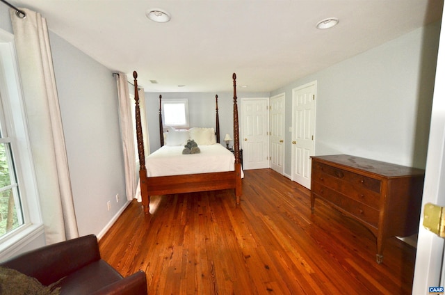 bedroom featuring wood finished floors, baseboards, and recessed lighting