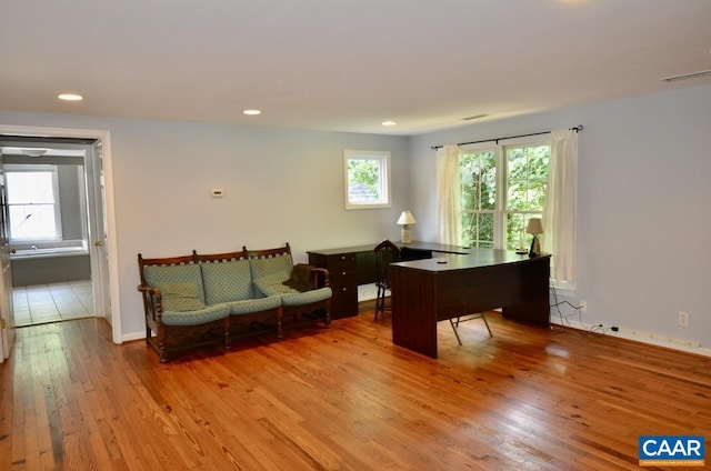home office featuring baseboards, hardwood / wood-style floors, and recessed lighting
